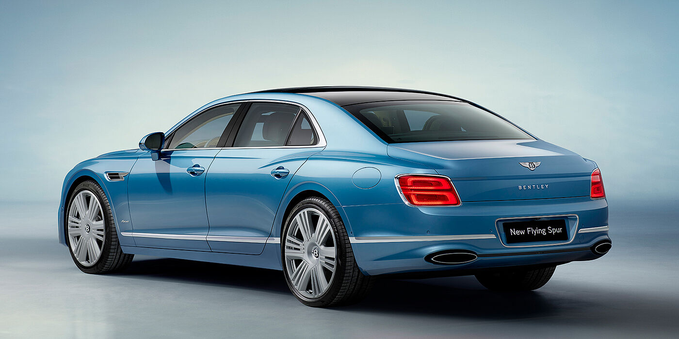 Bentley Abu Dhabi New Bentley Flying Spur Azure sedan rear view in Light windsor blue by Mulliner paint with 22 inch Azure wheels and chrome exterior details