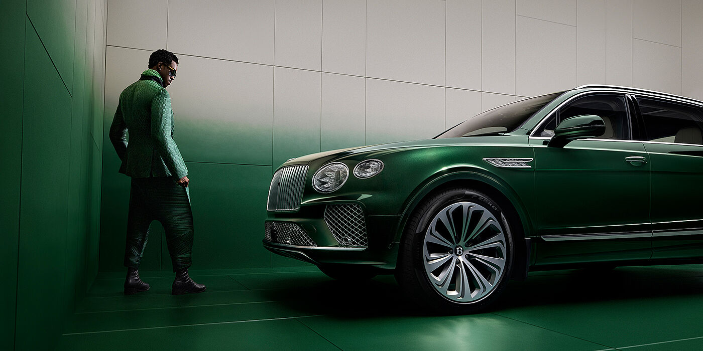 Bentley Abu Dhabi Wisdom K standing next to Bentley Bentayga Extended Wheelbase SUV in Light Emerald green paint in profile