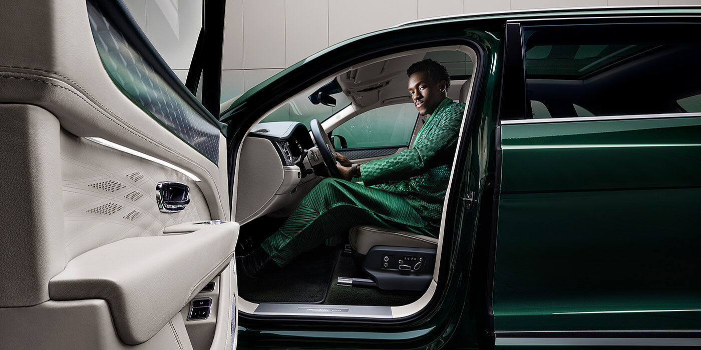 Bentley Abu Dhabi Wisdom K seated in Bentley Bentayga Extended Wheelbase SUV in Light Emerald green paint with door open
