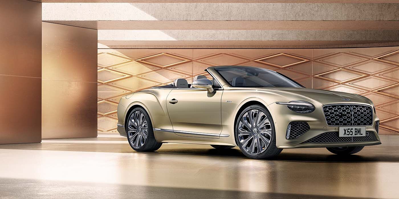 Bentley Abu Dhabi Bentley New Continental GTC Mulliner V8 hybrid front three quarters in Patina paint