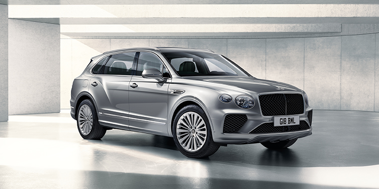 Bentley Abu Dhabi Bentley Bentayga Extended Wheelbase SUV front three quarter in Moonbeam paint with a grey background