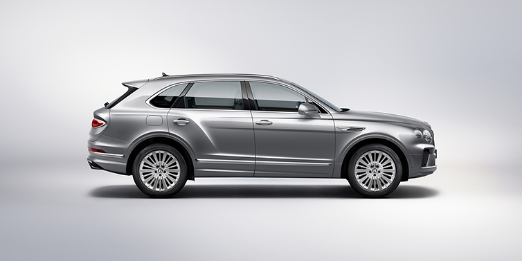 Bentley Abu Dhabi Bentley Bentayga SUV side profile in Moonbeam silver paint against white background featuring 21 inch 5 spoke wheels